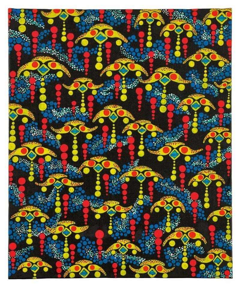 An image of a colorful collage repeating the same abstract design over and over in shades of yellow, red, and blue against a black background